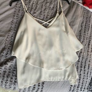 Cute white tank top with cross cross in back!